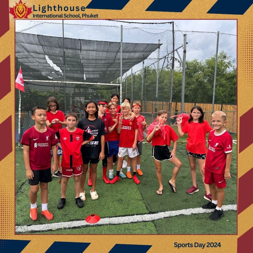 Children in a field, wearing red uniform for their team