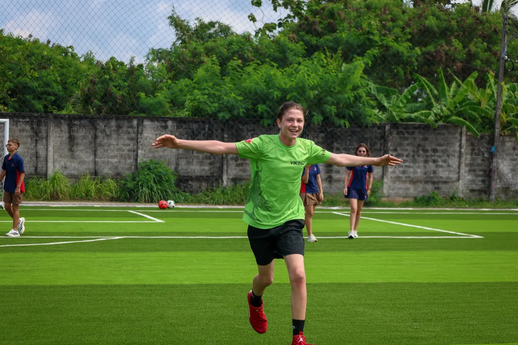 Student smiling in the football field